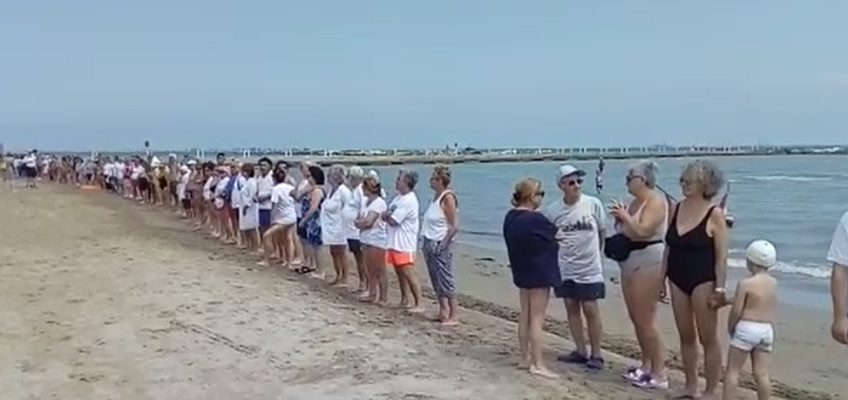 A FALCONARA UNA CATENA UMANA IN SPIAGGIA PER DIRE NO AL MURO DI RFI